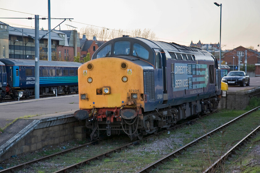 37604, stabled, Norwich yard 
 DRSs 37604 sits in the bay service platform adjacent to Norwich station. It has, along with a number of other of DRSs finest been involved in hauling trains around the Greater Anglia network to cover for unavailable units. This long term arrangement has become a interesting feature of Norfolk and Suffolk's railways over the last few years. 
 Keywords: 37604 Norwich yard DRS Direct Rail Services