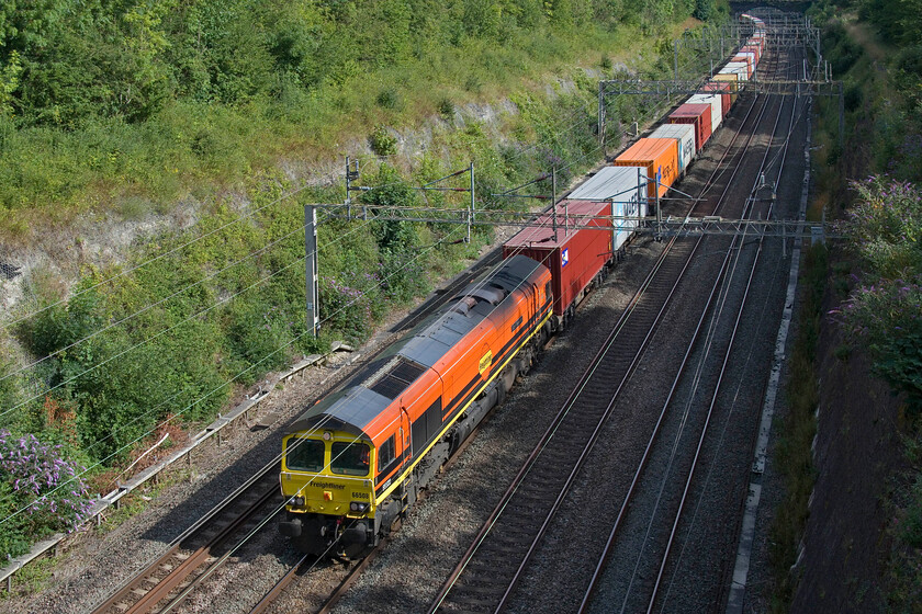 66508, 12.09 Felixstowe North-Crewe Basford Hall (4M67, 82E), Roade cutting 
 Running unusually early through Raode cutting, the 12.09 Felixstowe to Crewe Basford hall 4M67 Freightliner is led, in some glorious summer sunshine, by 66508 'City of Doncaster'. 
 Keywords: 66508 12.09 Felixstowe North-Crewe Basford Hall 4M67 Roade cutting Freightliner City of Doncaster