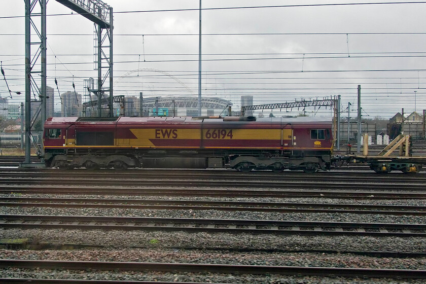 66194, 06.00 Willesden West London Junction-Bescot Yard (6R02, 17E), Wembley Yard 
 Whilst the trailing locomotive of the 6R02 engineering train heading back to Bescot Yard is in its EWS livery but DB branded the leading 66194 is absolutely standard as delivered back in 1999. It is seen as we pass Wembley Yard and will follow us along the WCML later in the afternoon but a much reduced and restricted pace! 
 Keywords: 66194 06.00 Willesden West London Junction-Bescot Yard 6R02 Wembley Yardx DB