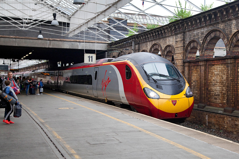 390047, VT 08.43 London Euston-Edinburgh (9S54), Crewe station 
 Our second train of the day, that took us all the way to Edinburgh, arrives at Crewe's platform eleven. The 08.43 Euston to Edinburgh was worked by 390047 and we enjoyed a spectacular journey in it to the Scottish capital. Note the passengers equipped for an overnight stay outdoors, and there were many more. They alighted at Warrington Bank Quay as they were attending the Creamfilelds festival at nearby Dearsbury. The headline acts this year were Calvin Harris, Avicii and Tisto. 
 Keywords: 390047 08.43 London Euston-Edinburgh 9S54 Crewe station