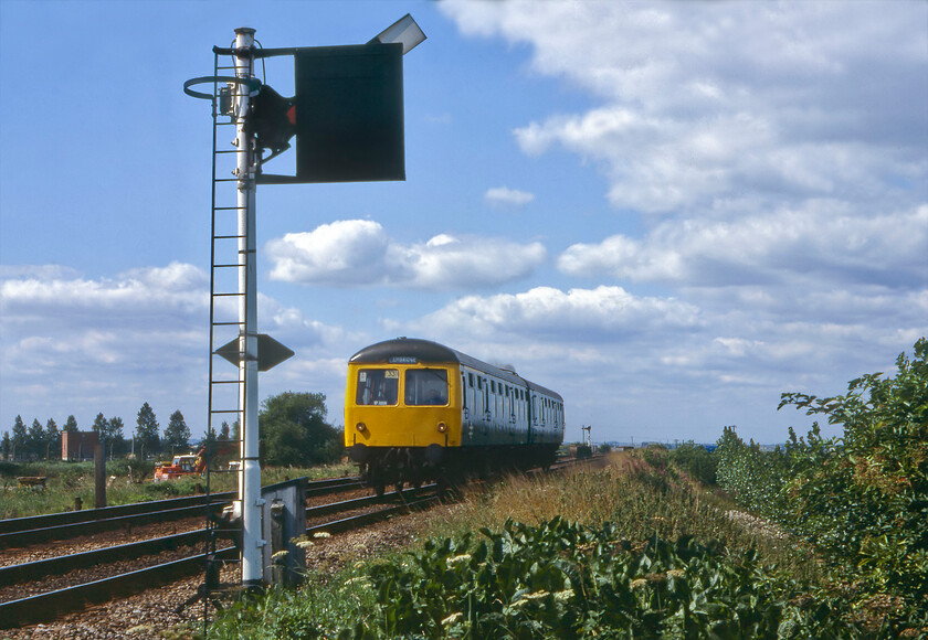 Class 105 DMU, 12.05 Peterborough-March, Whittlesey 
 The 12.08 Peterborough to Cambridge DMU shuttle approaches the first stop of its relatively short journey across the Fens at Whittlesey. The class 105 Cravens DMU is seen approaching the station taken from the level crossing that was controlled by a separate signalling cabin. During ECML diversions at the start of 2019 I stood in the same spot and took a similar photograph but this time of an HST, see.. https://www.ontheupfast.com/p/21936chg/25696216204/x43277-07-54-newcastle-london-king 
 Keywords: Class 105 DMU 12.05 Peterborough-March Whittlesey