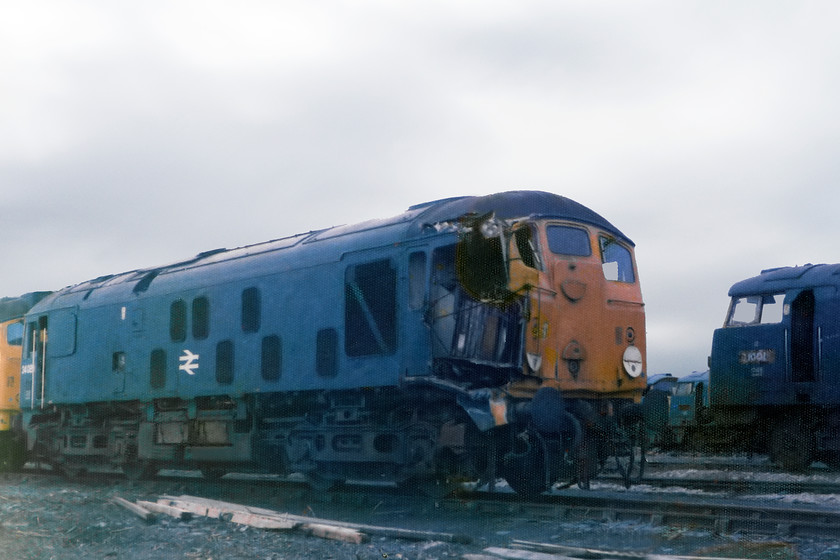 24135, 24089 & D1001, scrap-line, Swindon Works 
 Swindon Works did not only deal with West Country engines. Here, 24135 and 24089 await cutting up. They were withdrawn in January 1976 following colliding with each other at Bidston Dock on Merseyside on 16.12.75. If the class 24s had not been on-notice, it is likely that these two would have gone to Crewe and have repairs authorised. D1001 'Western Pathfinder' is seen in the background. 
 Keywords: Swindon Works scrap lines 24135 24089