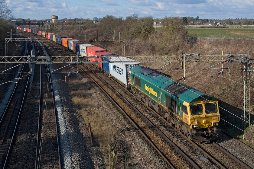 66585, 11.18 Lawley Street-London Gateway (4L46, RT), Victoria bridge 
 In some welcome afternoon sunshine, 66585 passes Victoria bridge, with my home village of Roade in the background, leading the 11.18 Lawley Street to London Gateway Freightliner service. 
 Keywords: 66585 11.18 Lawley Street-London Gateway 4L46 Victoria bridge