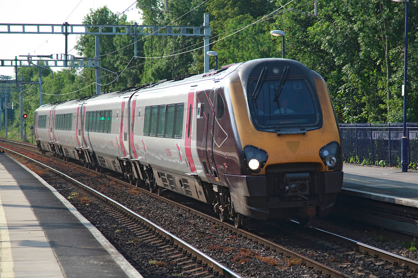 220024, XC 13.35 Newcastle-Guildford (1040, cancelled from Reading), Tilehurst station 
 220024 passes through Tilehurst station working the doomed 13.35 Newcastle to Guildford. I say doomed as it was cancelled from Reading just a few miles east from this spot. However, not a huge inconvenience for Guildford passengers as there are usually straightforward connections from Reading. It's amazing that ten years after Virgin Cross Country ceased to operate these trains that the shape of the Virgin branding badge can still be seen on their noses. 
 Keywords: 220024 1040 Tilehurst station