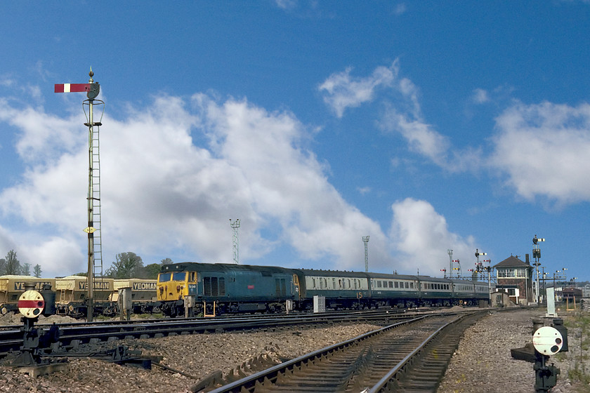 50049, 12.30 London Paddington-Paignton (1B76), Westbury South yard 
 50049 Defiance passes the doomed semaphores and signal box at Westbury South with the 1B76 12.20 Paddington to Paignton working. When this picture was taken, the signalling infrastructure only had a week remaining in use being abolished the following weekend as the precursor of the Westbury MAS programme that was to wipe all the mechanical signalling away in April 1984. I like the composition of this picture with the tall home post to the left dominating the scene and the two shunting ground signals in the foreground. Notice the line of chairs left on the sleepers in the immediate foreground remaining from a former set of points. As a spotting schoolboy when this photograph was taken, I would never have considered that as a retired professional well over forty years later that I would still be photographing the same locomotive still in operation on the mainline, see..... https://www.ontheupfast.com/p/21936chg/30037057484/x50049-458505-11-22-clapham-yard 
 Keywords: 50049 12.30 London Paddington-Paignton 1B76 Westbury South yard