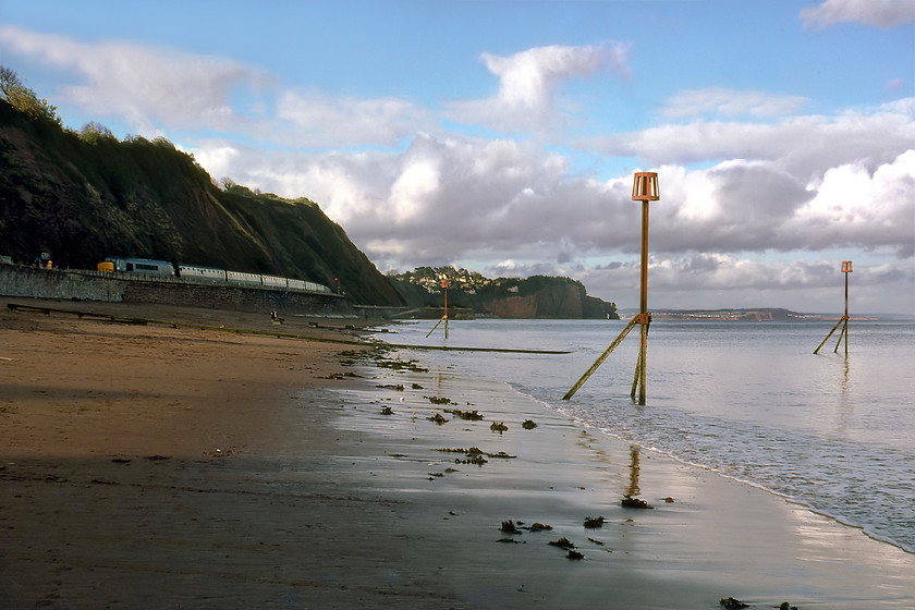 Class 45, unidentified down working, Teignmouth Sea Wall 
 In the late afternoon, an unidentified Class 45 or 46 Peak heads along the sea wall commencing it journey inland as it approaches Teignmouth. I am surprised at the almost complete lack of people out taking the sea air on this late summer bank holiday weekend?

A recording made at the same location of an up service can be heard on my Youtube channel at... https://youtu.be/m4SfL_YeTNs 
 Keywords: Class 45 unidentified down working Teignmouth Sea Wall Peak