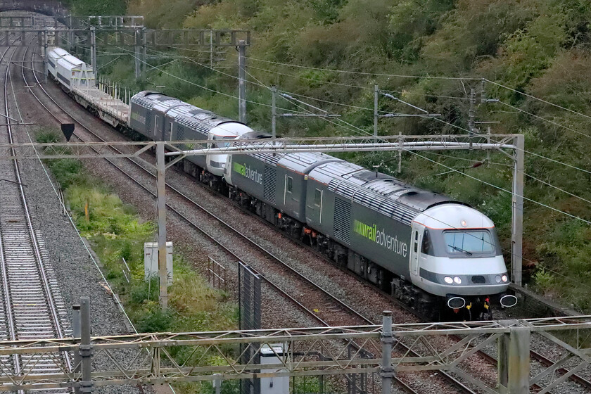 43468, 43480, 43484 & 43465, 09.29 Northampton TC Up Sidings-Wembley Reception Sidings (6Z83, 10L), A508 bridge 
 Many of us more seasoned enthusiasts remember the pre-internet days when we went out to the lineside never quite knowing what would turn up. This was a little bit like this as I had no idea what the mysterious 6Z83 would turn out to be until it appeared around the curve in Roade cutting. With over seven thousand horsepower available the 09.29 Northampton Up Sidings to Wembley Yard barrier move ought not be short of go! The Railadventure HSTs in the form of 43468, 43480, 43484 and 43465 lead rake of barrier vehicles through Roade heading south for some new stock move or other of which there are many at the moment. Based in Munich, Railadventure has made a name for itself across Europe as an 'interim operator 
providing support between rollout and the start of operations' according to their website at least. 
 Keywords: 43468 43480 43484 43465 09.29 Northampton TC Up Sidings-Wembley Reception Sidings 6Z83 A508 bridge Rail adventure