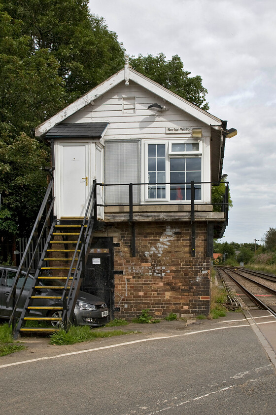 Norton West signal box (NE, 1910) 
 A view looking east of the gabled end of the 1910 Norton West signal box. The box is one of three at all corners of the triangular junction with the junction heading off to Norton South seen in the distance. The whole area is due for upgrading in the next few years with the semaphores and boxes swept away. 
 Keywords: Norton West signal box North Eastern Railway