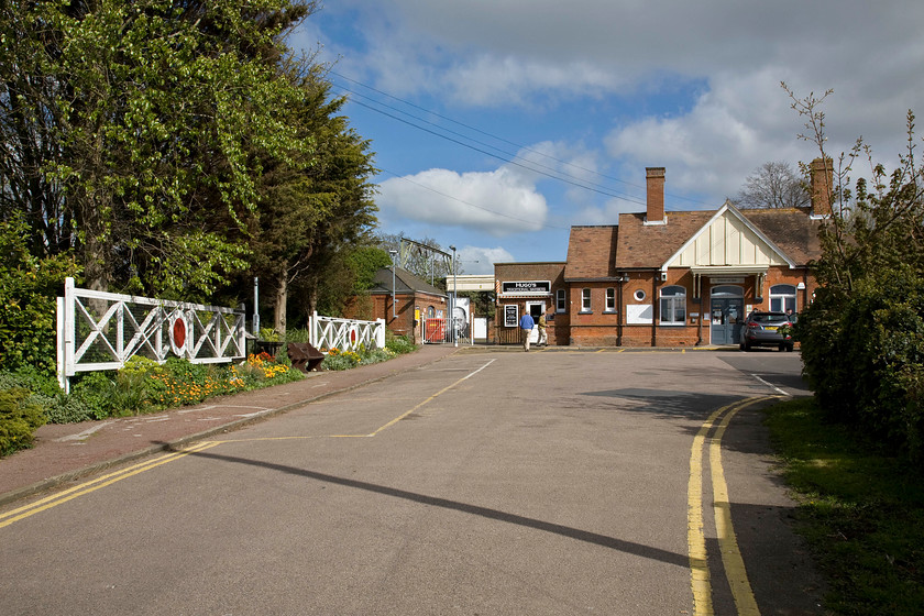 Frontage & old level crossing gates, Frinton-on-Sea station 
 The attractive station building at Frinton-on-Sea was constructed in 1888 to a design similar to several others in Essex featuring the large central gable. However, the twin circular windows (with only one in view in this image) are unique to Frinton. The Frinton & Walton Heritage Trust do a lot of work in the area and maintain the station and its environs to a high standard. This includes the installation of the level crossing gates that were previously located on Frinton's level crossing just to the east of the station. They were replaced by automated barriers just five years ago in 2009. 
 Keywords: Frontage & old level crossing gates Frinton-on-Sea station