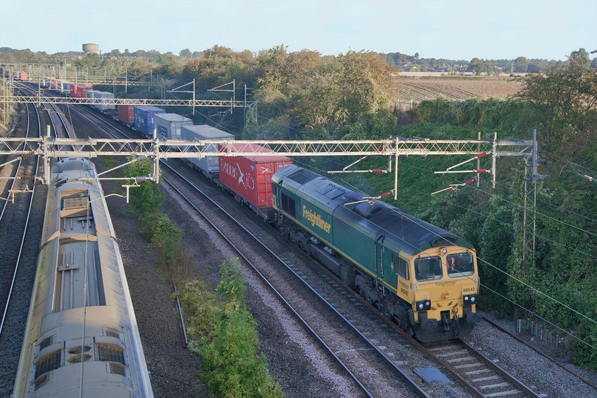 66542, 02.08 Trafford Park-Ipswich (4L97) & 390006, VT 06.10 Manchester Piccadilly-London Euston (1A05, 5L), Victoria bridge 
 66542 heads the 02.08 Trafford Park to Ipswich Freightliner past Victoria bridge just south of Roade as a 390006 'Rethink Mental Illness' passes it forming the 06.10 Manchester Picadilly to Euston. 
 Keywords: 66542 02.08 Trafford Park-Ipswich 4L97 390006 06.10 Manchester Piccadilly-Londn Euston 1A05 Victoria bridge