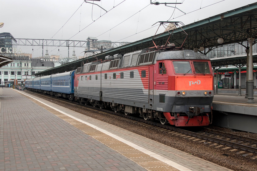 CHS7-089, 20.28 Moscow Belorussky-Brest (095B), Moscow Belorussky station 
 Articulated RZD CHS7-089 will make extremely light work of a five-coach train with its impressive power, perhaps other stock will be added en-route? The blue stock denotes that it's a train to the former USSR state of Belarus. In this case train 095B, the 20.28 to Brest, a city on the far western side of Belarus on the border with Poland. This is a seventeen-hour journey with the train travelling overnight arriving at lunchtime next day. 
 Keywords: CHS7-089 20.28 Moscow Belorussky-Brest 095B Moscow Belorussky station