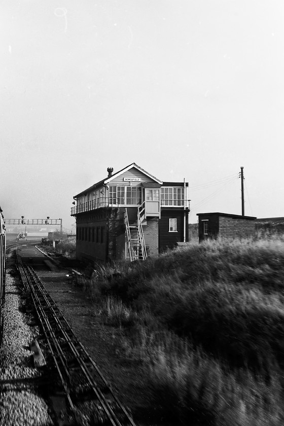 Bowesfield signal box (NER, 1905) 
 A rather rushed photograph taken from the passing DMU at some speed sees the large Bowsfiled signal box. This was, and still is for that matter, at the far eastern end of the triangle of tracks where the Middlesbrough line meets the Durham coast route just south of Stockton-on-Tees. This NER box dating from 1905 was photographed during my last visit to the area in 2014 taken from a better angle than seen here, see..... https://www.ontheupfast.com/p/21936chg/30018035730/x34-bowesfield-signal-box 
 Keywords: Bowesfield signal box North Eastern Railway NER