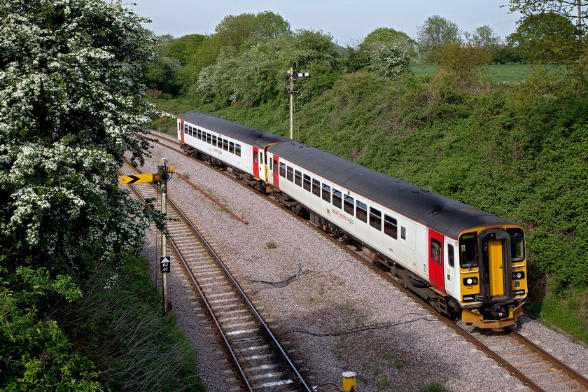 153322 & 153314, LE 15.50 Norwich-Lowestoft (2J82, 12L), Reedham 
 Two single car class 153s approach Reedham Swing Bridge working the 15.50 Norwich to Lowestoft working. The home signal had been returned to danger as the first carriage passed the post! With the hawthorn (crataegus monogyna) in full flower it can only be late springtime! 
 Keywords: 153322 153314 2J82 Reedham