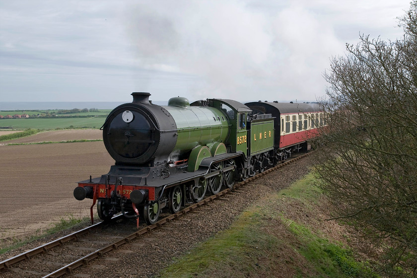 8572, 09.45 Sheringham-Holt, Kelling bank 
 With hardly a wisp of exhaust former LNER B12 8572 makes easy work of Kelling bank leading the Poppy Line's 09.45 Sheringham to Holt train. This spot has recently been opened up as volunteers have been involved in a lot of lineside clearance in the vicinity largely to combat fire risk in the summer months rather than to please photographers! 
 Keywords: 8572 09.45 Sheringham-Holt Kelling bank Poppy Line NNR North Norfolk Railway LNER B12 4-6-0