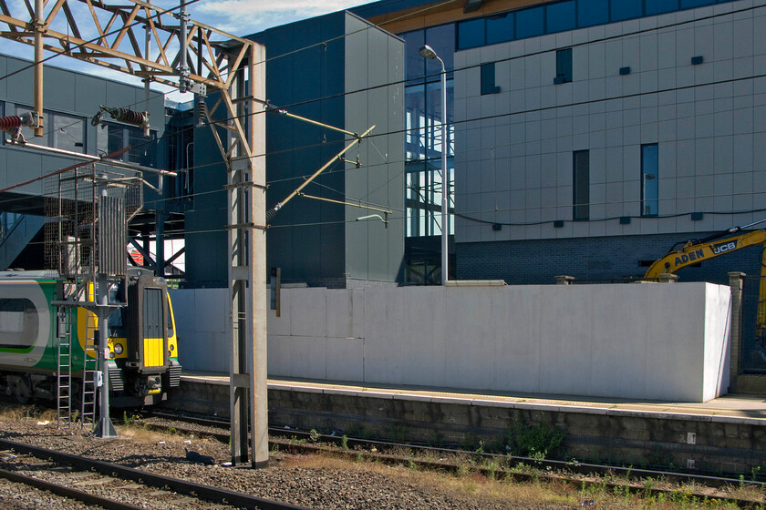 350244, LM 09.33 Birmingham New Street-London Euston (1W08), Northampton station with new station under construction 
 The re-building of Northampton (Castle) station is well underway with the main building now largely complete. The new station footbridge complete with its lift towers is also looking as though it is largely complete. However, the internal fitting out of the two structures now has to take place and this may well take as much time as the initial construction. 350244 waits under the new bridge ready to work the 09.44 Birmingham New Street to Euston forward. 
 Keywords: 350244 09.33 Birmingham New Street-London Euston 1W08 Northampton station with new station under construction London Midland LMR Desiro