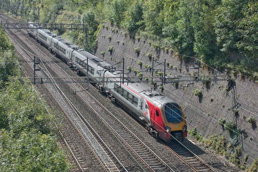 Class 221, VT 10.10 London Euston-Chester (1D84, RT), Roade cutting 
 According to the latest news from Rail and the wider railway press, the days of running diesels under the wires could at last be coming to an end. This is a crazy practice that does nothing for the efficiency of the modern railway and one that we should be keen to see the back of. Here, one of Virgins class 221 Voyagers passes Roade cutting with the 10.10 London Euston to Chester. This type of service should soon be operated by a bi-mode unit if the new operator sticks to its promises. 
 Keywords: Class 221 10.10 London Euston-Chester 1D84 Roade cutting