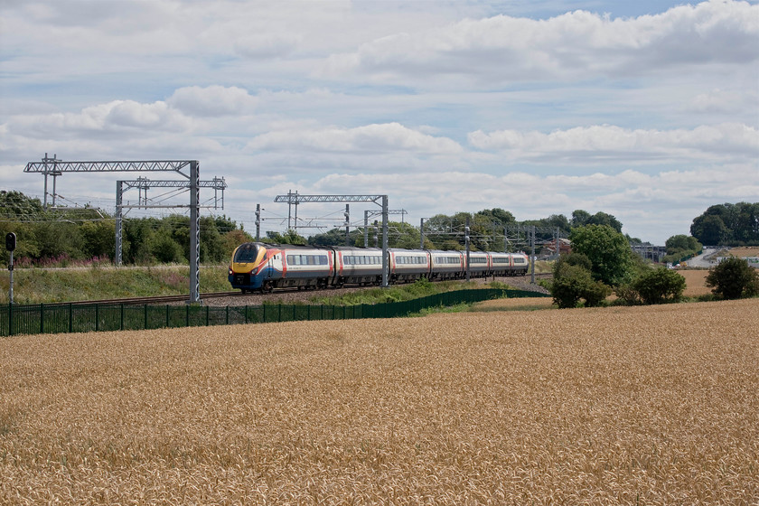 222001, EM 12.34 London St. Pancras-Nottingham (1D33, 1E), Irchester SP927667 
 I wandered away from Andy and the footbridge at Irchester hoping to capture an HST from this spot. However, 1D33, the 12.33 St. Pancras to Nottingham, turned up worked by a Meridian. Something had obviously gone wrong with EMR's planning on this day as this was one of a number of workings that were running incorrectly according to RTT. 222001 passes through some fields that will soon be ready for harvest. 
 Keywords: 222001 EM 12.34 London St. Pancras-Nottingham 1D33 Irchester SP927667 EMR East Midlands Railway