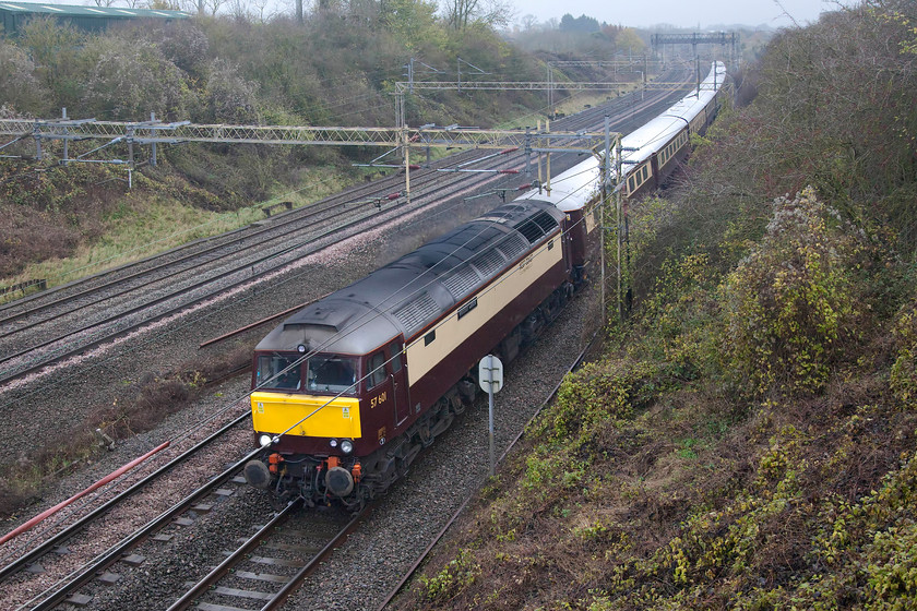 57601, the outward leg of the Northern Belle, 07.58 Chester-London Euston (1Z41), Victoria bridge 
 Looking very smart in its Northern Belle livery, they make an effort to maintain all their stock well, 57601 leads the 07.58 Chester to Euston charter past Victoria bridge just south of Roade. 57601 was re-built from Swallow liveried 47825 on 2001. Prior to that, it had three previous incarnations as 47590 (06.83-04.89), 47165 (02.74-06.81) and as D1759 form new in August 1964 making it just three months younger than myself! 
 Keywords: 57601 the Northern Belle 07.58 Chester-London Euston 1Z41 Victoria bridge