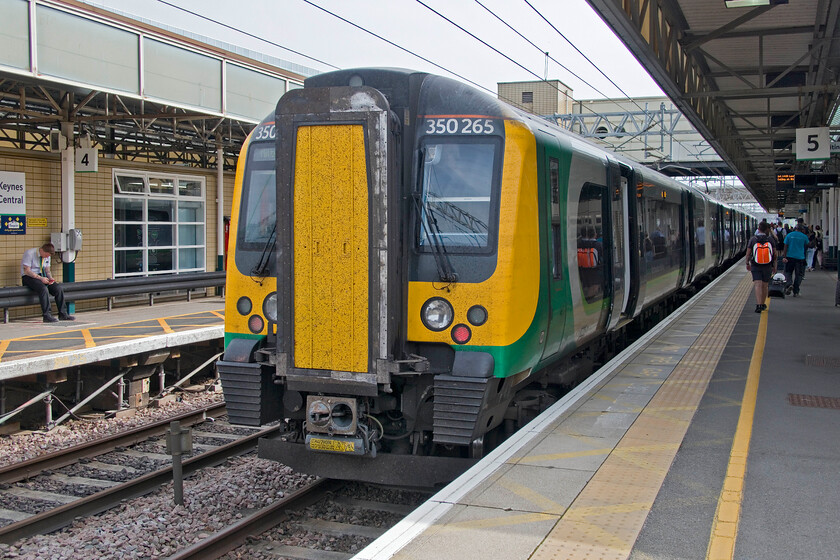 350265, LN 13.23 London Euston-Milton Keynes Central (1K39, 1E), Milton Keynes Central station 
 Having arrived at Milton Keynes I walked to the front of the train to capture 350265 which had already had its tail lights illuminated for the return journey to Euston. With the line still closed from Hanslope to Northampton a shuttle service remained in operation with the dreaded bustitution from here to Northampton. After being a little cold on our previous train from Brighton to St. Pancras due to over-efficient air conditioning on the 13.23 ex Euston Desrio operated service was far too hot and stuffy! 
 Keywords: 350265 13.23 London Euston-Milton Keynes Central 1K39 Milton Keynes Central station London Northwestern Desiro