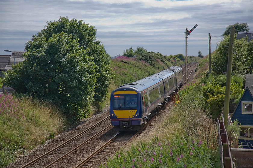 170404, SR 11.30 Edinburgh Waverley-Aberdeen (1A71), Newtonhill 
 170404 passes the village of Newtonhill approximately six miles south of Aberdeen. 170404 has just passed Newtonhill's down home signal working the 11.30 Edinburgh Waverley to Aberdeen ScotRail service. The village was once served by a station that closed relatively early on 11.06.56. 
 Keywords: 170404 11.30 Edinburgh Waverley-Aberdeen 1A71 Newtonhill