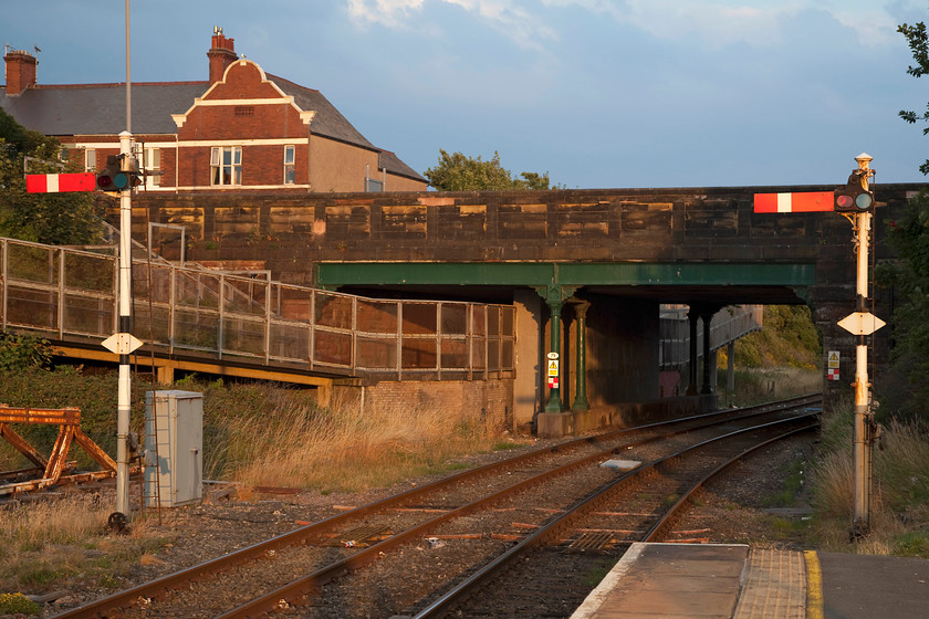 Starter signals, Barrow-in-Furness station 
 With a dramatic evening sky the view from the end of Barrow-in-Furness station. With Abbey Road bridge in the background the up starter signals stand out nicely against the stonework. 
 Keywords: Starter signals Barrow-in-Furness station