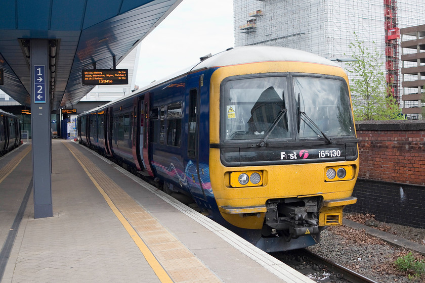 165130, GW 15.12 Reading-Newbury (2K66), Reading station 
 165130 waits at Reading's platform one with the 15.12 stopper to Newbury. I took this service all the way following my visit to the 'new' Reading station. I found the station very busy but with all the new concrete and slabs it seemed a little too sanitised. However, the public spaces are large with Network Rail and the architects appearing to make a real effort to future-proof the station in terms of it being able to manage increased passenger numbers. 
 Keywords: 165130 15.12 Reading-Newbury 2K66 Reading station