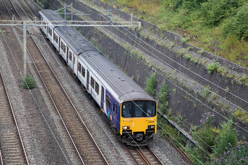 150006, 10.59 Neville Hill-Wolverton Centre Sidings (5H70, 17E), Roade cutting 
 An interloper from the north passes through Roade cutting! 150006 is close to its destination as the 5H70 10.59 Neville Hill to Wolverton Centre Sidings move. The unit is going to the works for attention probably relating to corrosion repairs. Either way, this unit, that I have not photographed before, is forty years old this year far outliving the first-generation DMUs that it replaced 
 Keywords: 150006 10.59 Neville Hill-Wolverton Centre Sidings 5H70 Roade cutting Northern