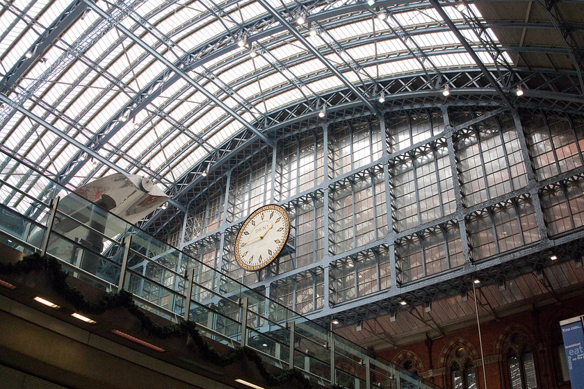 Interior, London St 
 The station clock dominates this view of the interior of St. Pancras station. The magnificent glazed wrought iron framework allows light to flood in creating a lovely environment that has proved appealing not only to passengers but also shoppers, like my wife! 
 Keywords: London St. Pancras station