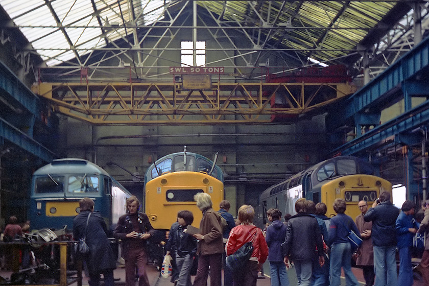 47527, 40064 & 40168, undergoing overhaul, Crewe Works 
 47527 had moved about in its life being ostensively a north eastern engine. It had spells in Scotland and the West Country. It was withdrawn in 1992 as an Inter-City Swallow engine and cut up at Bristol. It was named 'Kettering' for the last 3 years of its life. 40064 was initially a Scottish engine before moving south. It was withdrawn in April 1982 and returned to Crewe's Melt Plant for a protracted and painful death! Thanks to some help from a fellow enthusiast, Keith Riley who was also there on the day, I can now identify the third locomotive to the right as 40168, my notes from the day let me down on this occasion. 40168 lasted in service until the end of November 1984, being withdrawn and stored at Crewe Diesel Depot and then the works languishing on until final cutting in August 1986. Note the clothing and accessories being worn by the enthusiasts, it could only be the 1970s! 
 Keywords: 47527 40064 40168 overhaul Crewe Works