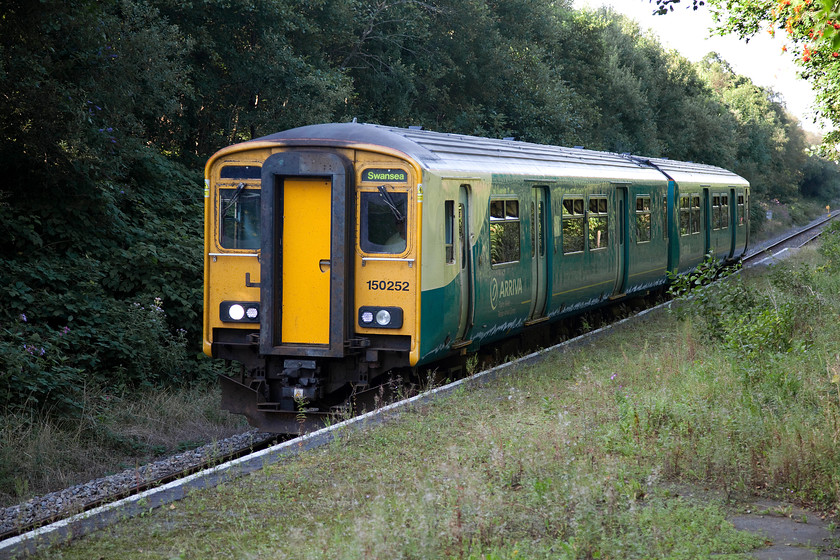 150252, AW 14.05 Shrewsbury-Swansea (2V10), Pontarddulais station 
 150252 arrives at Pontarddulais station working the 14.05 Shrewsbury to Swansea service. It is passing the un-used and fenced off section of the platform but I cannot help that feeling this is a poor greeting to passengers. This train has traversed the Central or the Heart of wales line, a distance of some 103 miles and is now a few stops away from its destination. 
 Keywords: 150252 14.05 Shrewsbury-Swansea 2V10 Pontarddulais station