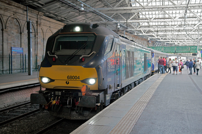 68004, SR 17.08 Edinburgh Waverley-Glenrothes with Thornton (2G13), Edinburgh Waverley station 
 A good number of the passengers on platform two at Waverley station appeared to be enthusiasts seeking to to enjoy the treat of some loco. hauled miles! 68004 'Rapid' has just arrived with the ECS from Motherwell and will work forward as the 17.08 to Glenrothes with Thornton. 
 Keywords: 68004 17.08 Edinburgh Waverley-Glenrothes with Thornton 2G13 Edinburgh Waverley station