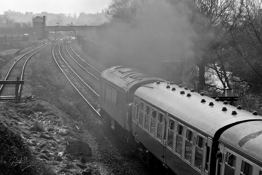 46013, outward leg of The Pines Express, 07.48 London Paddington-Weymouth (via Bristol & various freight lines), Hawkeridge Junction 
 With a smokey exhaust, 46013 brings The Pines Express into Westbury station, seen in the background, past Hawkeridge Junction. I know that Im breaking the photographic rules with this image taken straight into the afternoon sunshine but I like the effect the exhaust creates. Notice the remnants of the previous night's snowfall on the grass in the foreground. 
 Keywords: 46013 The Pines Express 07.48 London Paddington-Weymouth Hawkeridge Junction