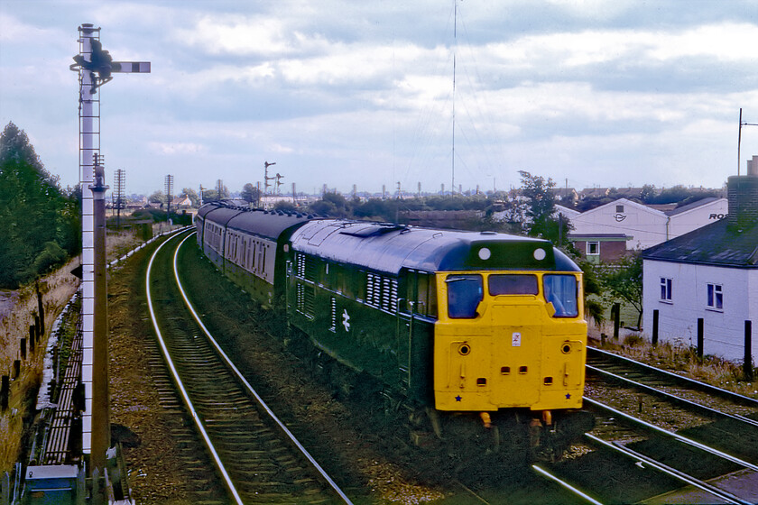 31234, 13.40 Norwich-Birmingham New Street (1M67), March South signal box 
 Of very dubious quality, this is another slide rescued from the 1981 rejects box. It has needed a fair amount of Photoshop work to bring things back from the abyss with the original exposure being probably two stops under what it should have been as well as being badly framed! Taken from inside March South Junction signalbox 31234 slows for its stop at March station leading the 1M67 13.40 Norwich to Birmingham New Street service. Today this service is handled by an inferior unit of some kind be it a 158 or a 170, hardly progress from a long rake of comfy MK. 1s as seen here. 
 Keywords: 31234 13.40 Norwich-Birmingham New Street March South signal box