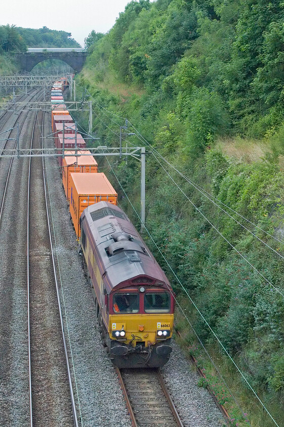 66063, 12.30 Trafford Park-London Gateway (4L56, 8L), Hyde Road bridge 
 Still wearing its EWS livery 66063 is one of my most frequently photographed members of the class, for example, captured in a different county in very different weather, see.... https://www.ontheupfast.com/p/21936chg/23791615204/x66063-knottingley-station In this scene it is slogging through Roade cutting leading the 4L56 12.30 Trafford Park to Felixstowe service. 
 Keywords: 66063 12.30 Trafford Park-London Gateway 4L56 Hyde Road bridge EWS DB