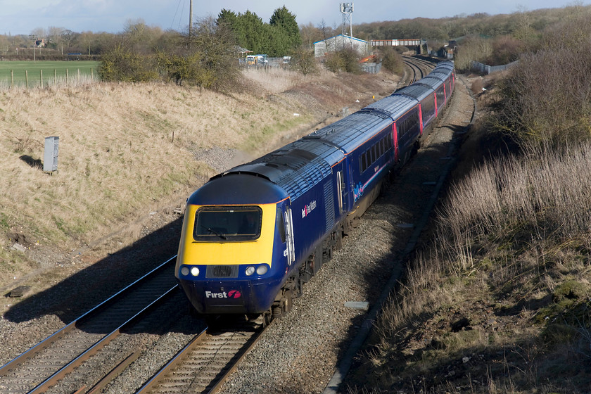 43158, GW 13.30 London Paddington-Bristol Temple Meads (1C16), Steppingstone Lane, Bourton SU234875 
 A smashing picture of 43158 passing Bourton at the far westerly extremity of Oxfordshire leading the 1C16 13.30 Paddington to Bristol Temple Meads. I am standing on a farm occupation bridge at the end of the delightfully named Steppingstone Lane that was more of a muddy track than a lane. Indeed, I made the error of driving down to the spot rather than parking the car and walking. I ended up getting the car stuck in the mud up to the axles only just managing to get it out as I had some tools in the boot that enabled me to lay a temporary track of stone and gravel to get me going. The underneath, wheel arches and sides of the poor Saab were absolutely caked in mud! The bridge in the background of this image marks the site of Shrivenham station (closed 07.11.64) with the clear land either side of the up and down lines being where the station loop lines ran. 
 Keywords: 43158 13.30 London Paddington-Bristol Temple Meads 1C16 Steppingstone Lane, Bourton SU234875