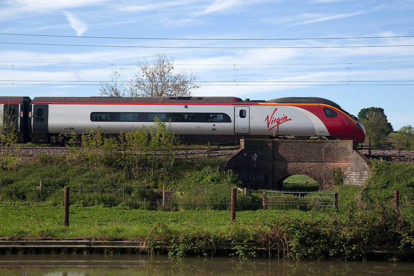 390137, VT 07.20 London Euston-Manchester Piccadilly (1H09, 1E), Bugbrooke SP679564 
 A side-on shot of 390137 'Virgin Difference' passing over a diminutive farm bridge near Bugbrooke in Northamptonshire with the 1H09 07.20 Euston to Manchester Piccadilly. The water in the foreground is the Grand Union Canal 
 Keywords: 390137 1H09 Bugbrooke SP679564