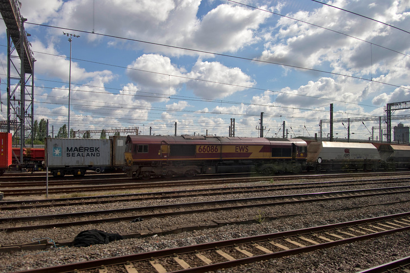 66086, down freight, Wembley yard 
 Taken from the train as we pass through Wembley yard, 66086 is seen at the head of a down freight working. 
 Keywords: 66086 Wembley yard