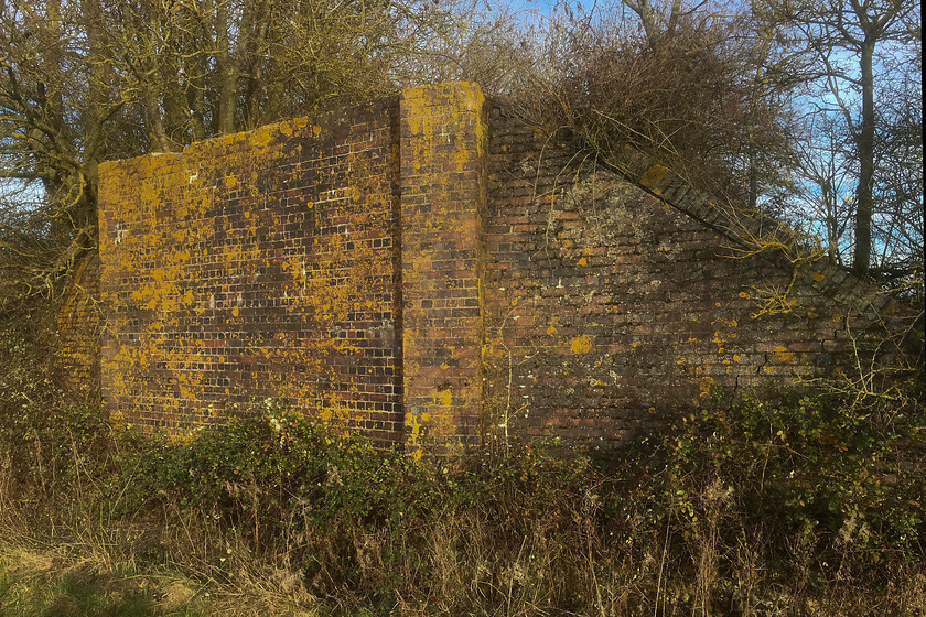 Former SM & J bridge, SP773518 
 The remains of, what I believe to be, bridge 167 still stands proudly at a field boundary between Roade and the M1 motorway. This bridge carried the single track section of the SM & J railway between the remote Ravenstone Wood Junction and Roade. The path where I am standing is part of the 230 mile Midshires Way. 
 Keywords: SM &J bridge SP773518