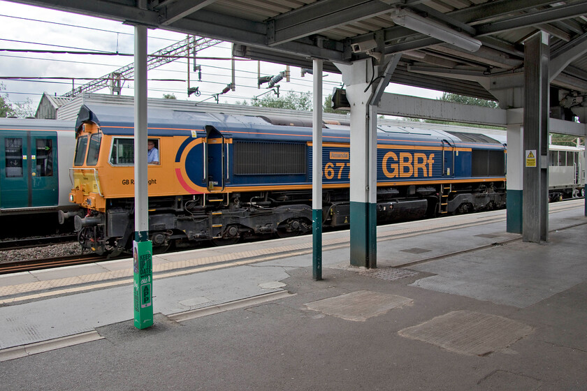 66771, 10.15 Kidderminster-Tonbridge West Yard (6Z66, 20L), Northampton station 
 We had overtaken this mysterious train as we approached Rugby on our return journey from Liverpool. Thinking that I would not see it after arrival at Northampton the failure to get a taxi home from the station enabled me to get a photograph of it through the railings! 66771 'Amanda' leads the 10.15 Kidderminster to Tonbridge West infrastructure train at this point running nearly two hours late. I have since discovered that this train was Network Rail/GBRf's new 'smart' weedkilling train returning from trials on the Severn Valley Railway to its base in Kent. 
 Keywords: 66771 10.15 Kidderminster-Tonbridge West Yard 6Z66 Northampton station Amanda