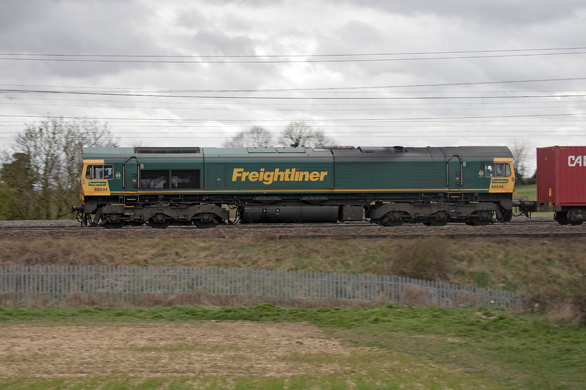 66544, 12.57 Birch Coppice-Felixstowe North (4L57, 6E), between Roade & Ashton 
 The 4L57 12.57 Birch Coppice to Felixstowe North passes the open countryside between Roade and Ashton just south of Northampton. This side view of 66544 shows off the huge Commonwealth Co-Co bogies and the underslung fuel tank that has a capacity of 6,400 litres. 
 Keywords: 66544 12.57 Birch Coppice-Felixstowe North 4L57 between Roade & Ashton Freightliner