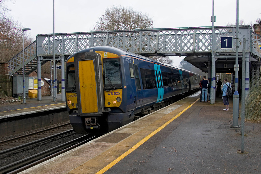 365625, SE 10.58 Dover-London Charing Cross (2W34, 1E), Sandling station 
 365625 arrives at Sandling station working the 10.58 Dover to Charing Cross. It's nice to see the original latticed wrought iron footbridge still in place and that it hasn't been replaced by a ghastly modern monstrosity. Sandling used to be named Sandling Junction as it was the point where the short three mile branch to Sandgate diverged. One of the two former platforms that served the branch was still intact just outside the station building to the right of where I am standing. 
 Keywords: 365625 10.58 Dover-London Charing Cross 2W34 Sandling station