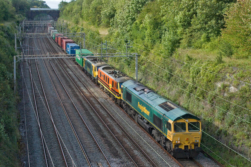 66536, 90014 & 90049, 10.20 Trafford Park-Felixstowe North (4L90, 3E), Hyde Road bridge 
 Superpower for the 4L90 10.20 Trafford Park to Felixstowe Freightliner service as it passes Roade or it would be if all locomotives were in operation! With just the leading 66536 operational it would be working hard leading the fully loaded train as well as the two dead-in-tow 90014 Over The Rainbow' and 90049. With reports that Freightliner are to sideline its AC locomotives due to the high costs of electricity in favour of their diesels, I wonder if the 90s were being moved for storage purposes. 
 Keywords: 66536 90014 90049 10.20 Trafford Park-Felixstowe North 4L90 Hyde Road bridge Freightliner Over The Rainbow