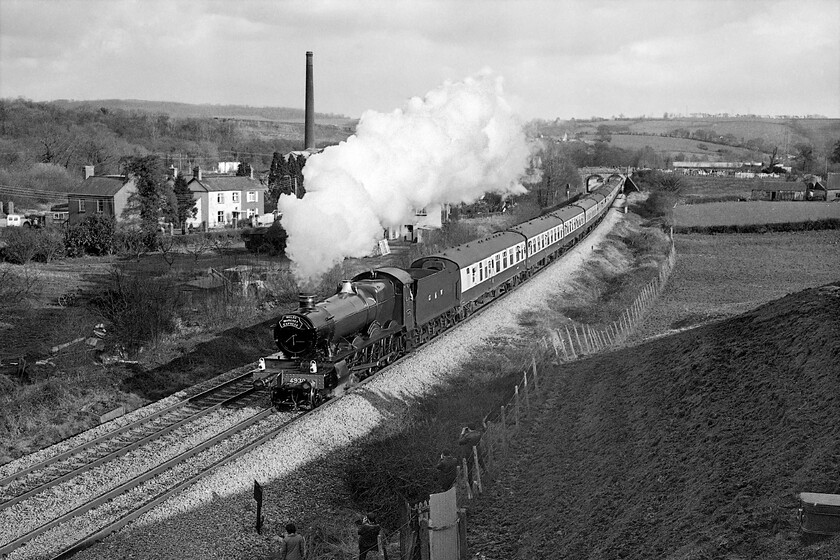 4930, return leg of The Welsh Marches Express, 15.35 Newport-Shrewsbury, Caerleon ST330923 
 A second photograph of 4930 'Hagley Hall' as it heads back towards Hereford and thence onwards to Crewe leading The Welsh Marches Express charter. I was using two cameras on this day with my Pentax ME Super loaded with Ilford FP4 film and fitted with its standard prime lens taking this image. The chimney in the background still exists being in the middle of the Star Trading estate at Ponthir near to Caerleon. This superb and elevated vantage point is still possible today but the view is somewhat compromised by tree growth and the construction of a faceless housing development on the land to the left of the train. Of course, Hagley Hall is still with us too. At the time of writing (December 2021) it is coming to the end of a protracted rebuild that has taken some eight years. Here's to it steaming on the Welsh Marches again sometime in the, not too distant future! 
 Keywords: 4930 The Welsh Marches Express, 15.35 Newport-Shrewsbury, Caerleon ST330923 Hagley Hall