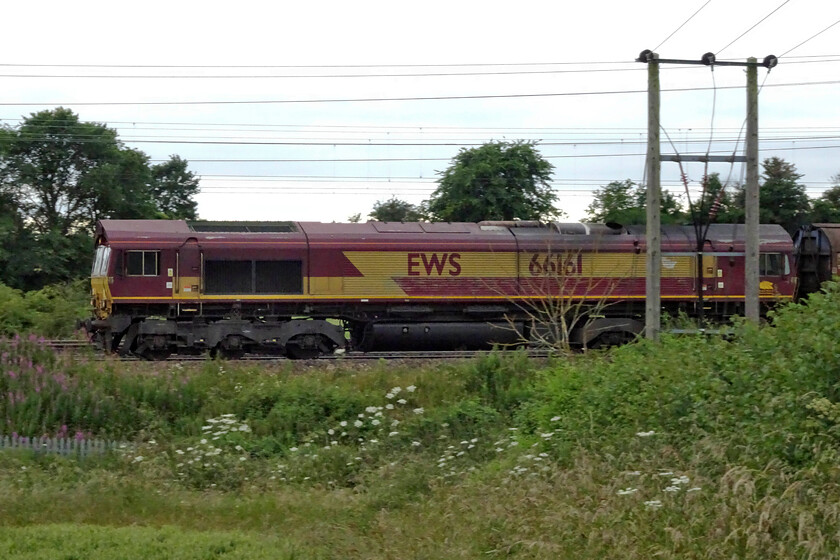 66161, 14.59 DIRFT-Dollands Moor (6O71, 1L), between Roade & Ashton 
 Looking at the faded paint on the flanks of 66161 as it passes between Roade and Ashton I suspect that this example of an EWS liveried and branded locomotive will be visiting the paint shop soon. It is leading the daily down water train empties that left Daventry at 14.59 heading for Dollands Moor where the wagons will then head back to the continent through the tunnel. 
 Keywords: 66161 14.59 DIRFT-Dollands Moor 6O71 between Roade & Ashton EWS