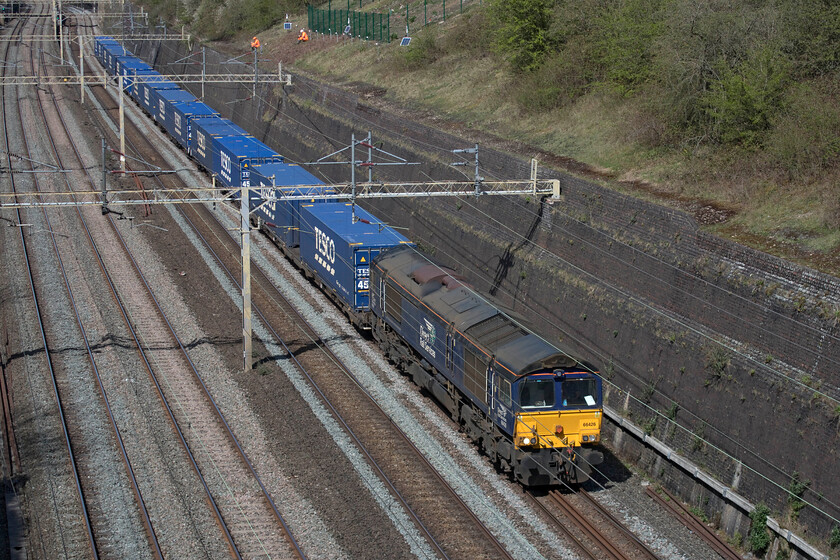 66426, 13.09 DIRFT-Tilbury (4L48, 2L), Roade cutting 
 The daily 4L48 13.09 (or thereabouts) Daventry to Tilbury DRS-operated Freightliner makes its way through Roade cutting. When well loaded it is generally hauled by a Class 88 that makes very light work of the train but today with a light load a Class 66 was deemed more appropriate or perhaps it was just 66426 was the only locomotive available? 
 Keywords: 66426 13.09 DIRFT-Tilbury 4L48 Roade cutting DRS Direct Rail Services