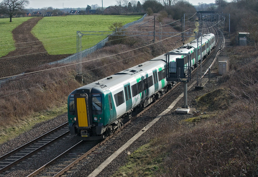 350370, LN 10.46 London Euston-Crewe (1U31, 1L), A45 Weedon bypass bridge 
 My first ever picture taken from the A45 Weedon bypass bridge that was opened less than two months previous to this visit. 350370 swings round on one of the many sharp and cambered curves of this section of line with the 10.46 Euston to Crewe. 
 Keywords: 350370 10.46 London Euston-Crewe 1U31 A45 Weedon bypass bridge