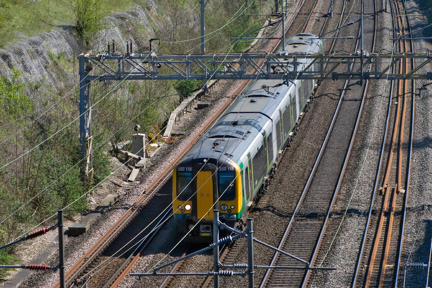 350118, LM 13.49 London Euston-Birmingham New Street (1W15), Roade cutting 
 350118 heads north through Roade cutting working the 13.49 Euston to Birmingham New Street service. Again, by using a zoom lens the train deep in the cutting becomes more of the subject matter rather than the cutting itself. 
 Keywords: 350118 13.49 London Euston-Birmingham New Street 1W15 Roade cutting London MIdland Desiro