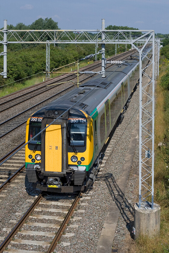 350124, LM 09.14 Birmingham New Street-London Euston (1Y22), Bradwell SP831391 
 350124 slows for its stop at Milton Keynes passing Bradwell with the 09.14 Birmingham New Street to London Euston London Midland service. Unfortunately, the return wire has once again caused problems as there were no other positions on this footbridge to take photographs, indeed, to take this shot I was standing on the top of my aluminium step ladder! 
 Keywords: 350124 09.14 Birmingham New Street-London Euston 1Y22 Bradwell SP831391 London Midland Desiro