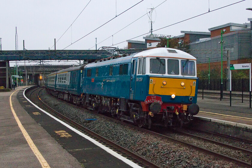 86259, outward leg of The Blackpool Can-Can, 07.13 London Euston-Blackpool North (1Z86, 5L), Wolverton station 
 There were plans that this UK Railtours charter was supposed to be hauled by 86101 or 86401 but with 86259 not in the mix. However, things conspired against the organisers so having to resort to the old favourite and reliable 'Les Ross/Peter Pan' to haul the train. Running, as usual, as 1Z86 The Blackpool Can Can left Euston at 07.13 heading for Blackpool North where it arrived just five minutes late. The train is seen on the down slow line passing through Wolverton station. 
 Keywords: 86259 The Blackpool Can-Can 07.13 London Euston-Blackpool North 1Z86 Wolverton station.jpg