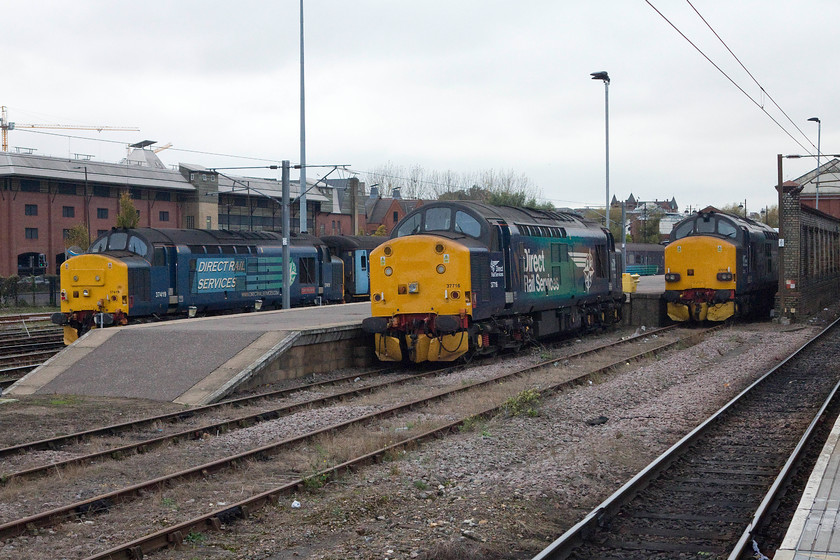 37716, 37419 & 37218, stabled, Norwich station 
 Due to the complete closure of all the lines out to Great Yarmouth and Lowestoft, the DRS class 37s that Greater Anglia hire in for use on the 'coastal trains' are seen sitting in the sidings next to Norwich station with no work. From left to right are 37717 'Carl Haviland 1954 - 2012', 37419 and 27218. 
 Keywords: 37716 37419 37218 stabled, Norwich station